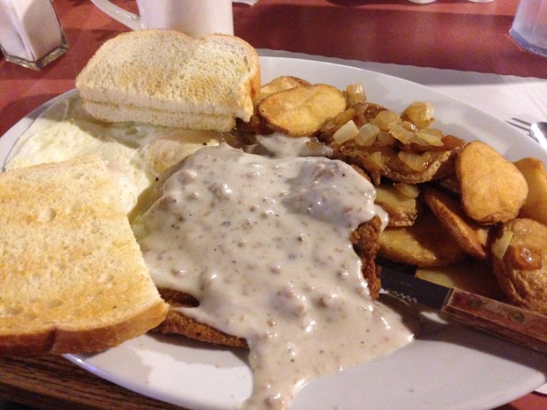 Chicken fried steak, gravy, and home fries at a local breakfast spot. #winning